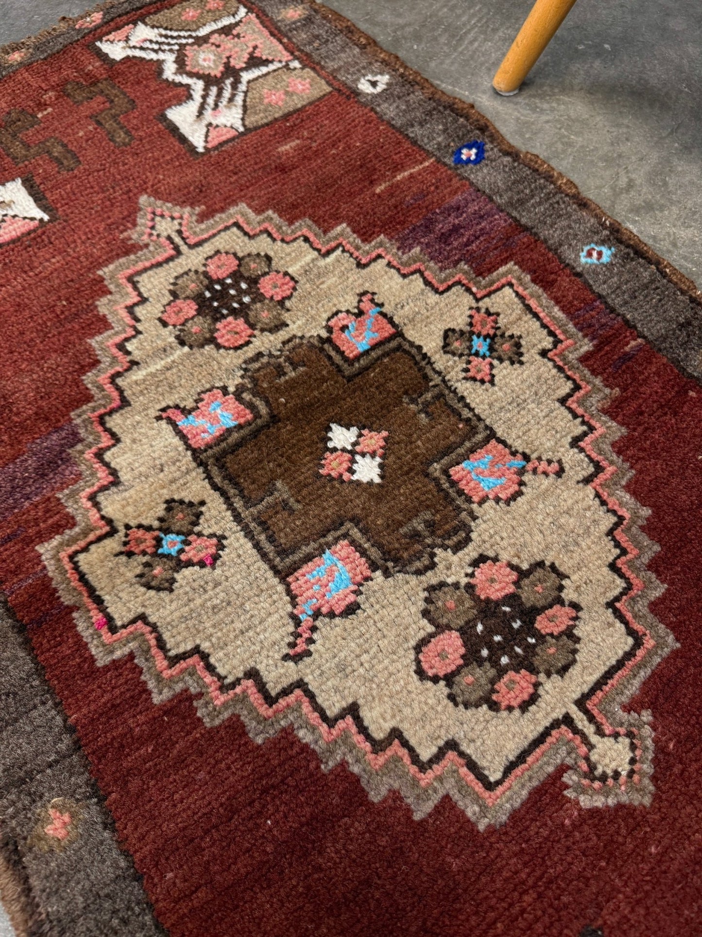 Vintage Turkish Yastik mini rug in chestnut brown with espresso outlines, camel-brown medallion, ivory highlights, muted blush and turquoise floral accents. Hand-knotted wool, 19x37 inches. One-of-a-kind vintage piece from the best rug shop in the San Francisco Bay Area, Indigo Rugs in Burlingame, CA. Free shipping included.