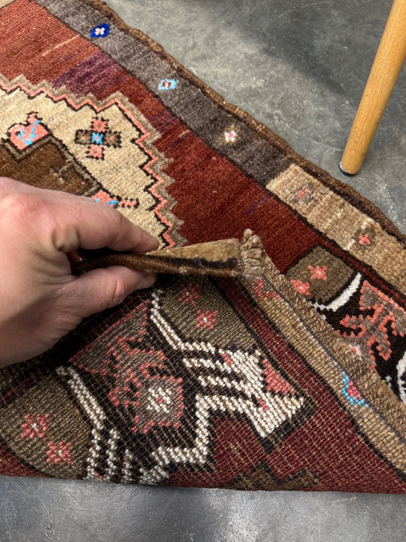 Vintage Turkish Yastik mini rug in chestnut brown with espresso outlines, camel-brown medallion, ivory highlights, muted blush and turquoise floral accents. Hand-knotted wool, 19x37 inches. One-of-a-kind vintage piece from the best rug shop in the San Francisco Bay Area, Indigo Rugs in Burlingame, CA. Free shipping included.