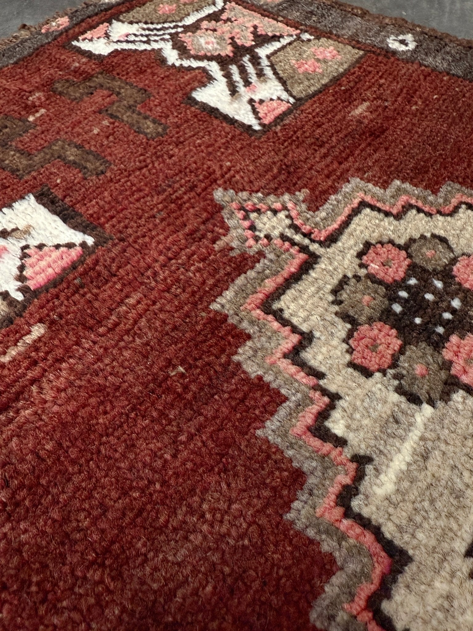 Vintage Turkish Yastik mini rug in chestnut brown with espresso outlines, camel-brown medallion, ivory highlights, muted blush and turquoise floral accents. Hand-knotted wool, 19x37 inches. One-of-a-kind vintage piece from the best rug shop in the San Francisco Bay Area, Indigo Rugs in Burlingame, CA. Free shipping included.