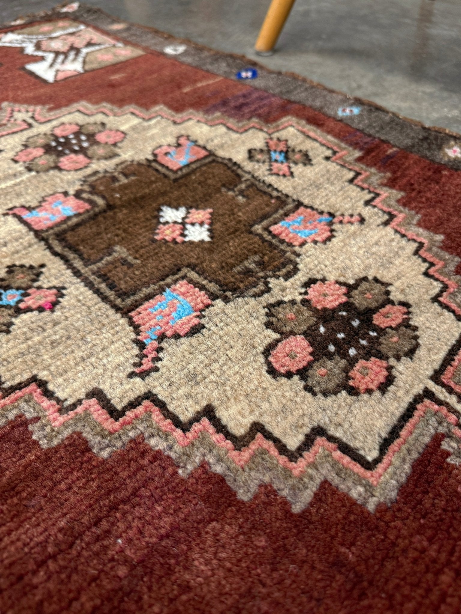 Vintage Turkish Yastik mini rug in chestnut brown with espresso outlines, camel-brown medallion, ivory highlights, muted blush and turquoise floral accents. Hand-knotted wool, 19x37 inches. One-of-a-kind vintage piece from the best rug shop in the San Francisco Bay Area, Indigo Rugs in Burlingame, CA. Free shipping included.