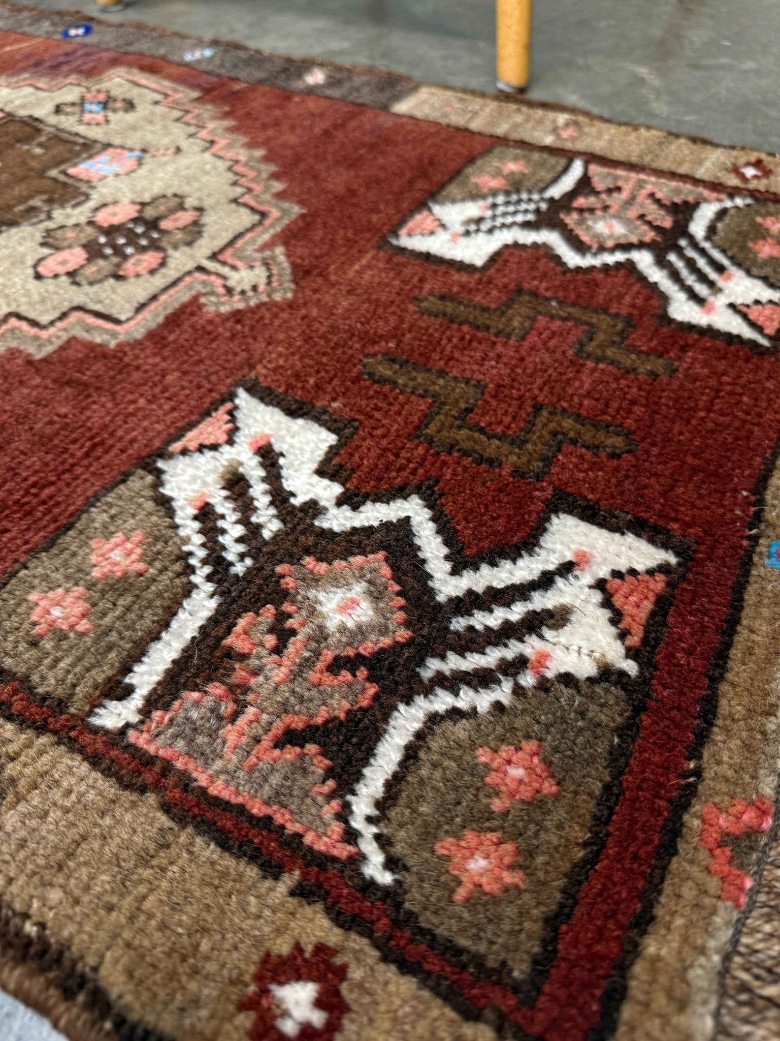 Vintage Turkish Yastik mini rug in chestnut brown with espresso outlines, camel-brown medallion, ivory highlights, muted blush and turquoise floral accents. Hand-knotted wool, 19x37 inches. One-of-a-kind vintage piece from the best rug shop in the San Francisco Bay Area, Indigo Rugs in Burlingame, CA. Free shipping included.