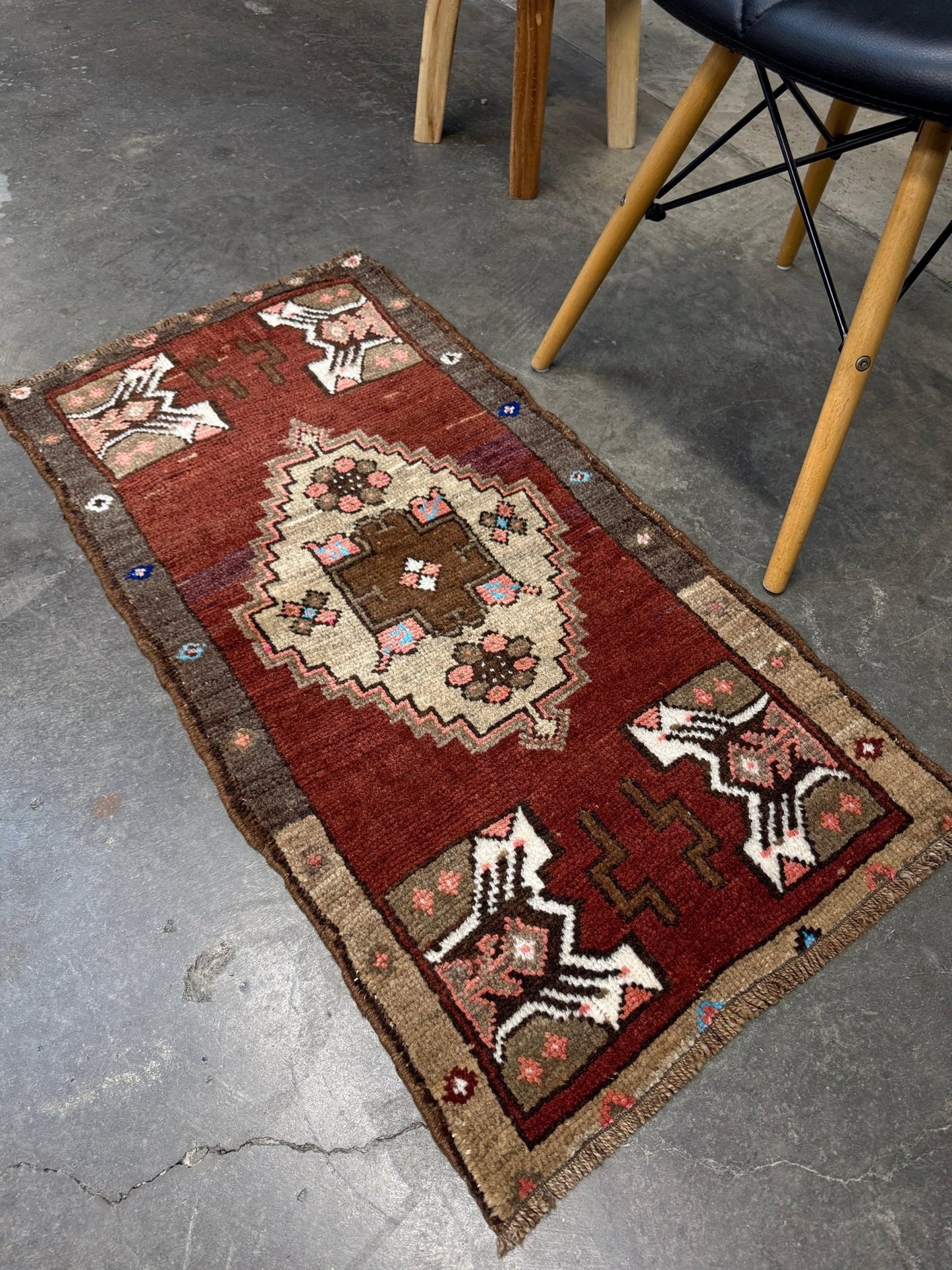 Vintage Turkish Yastik mini rug in chestnut brown with espresso outlines, camel-brown medallion, ivory highlights, muted blush and turquoise floral accents. Hand-knotted wool, 19x37 inches. One-of-a-kind vintage piece from the best rug shop in the San Francisco Bay Area, Indigo Rugs in Burlingame, CA. Free shipping included.