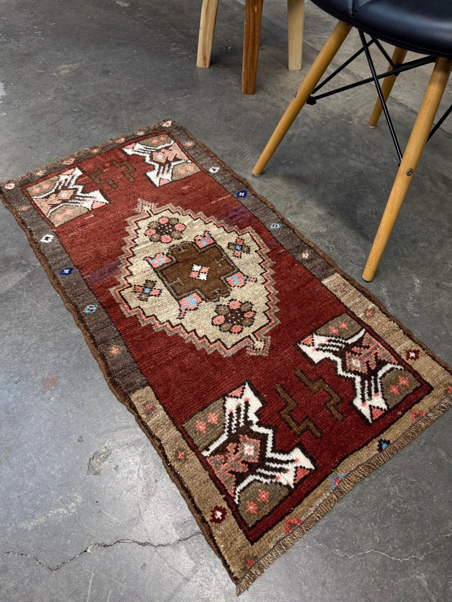 Vintage Turkish Yastik mini rug in chestnut brown with espresso outlines, camel-brown medallion, ivory highlights, muted blush and turquoise floral accents. Hand-knotted wool, 19x37 inches. One-of-a-kind vintage piece from the best rug shop in the San Francisco Bay Area, Indigo Rugs in Burlingame, CA. Free shipping included.