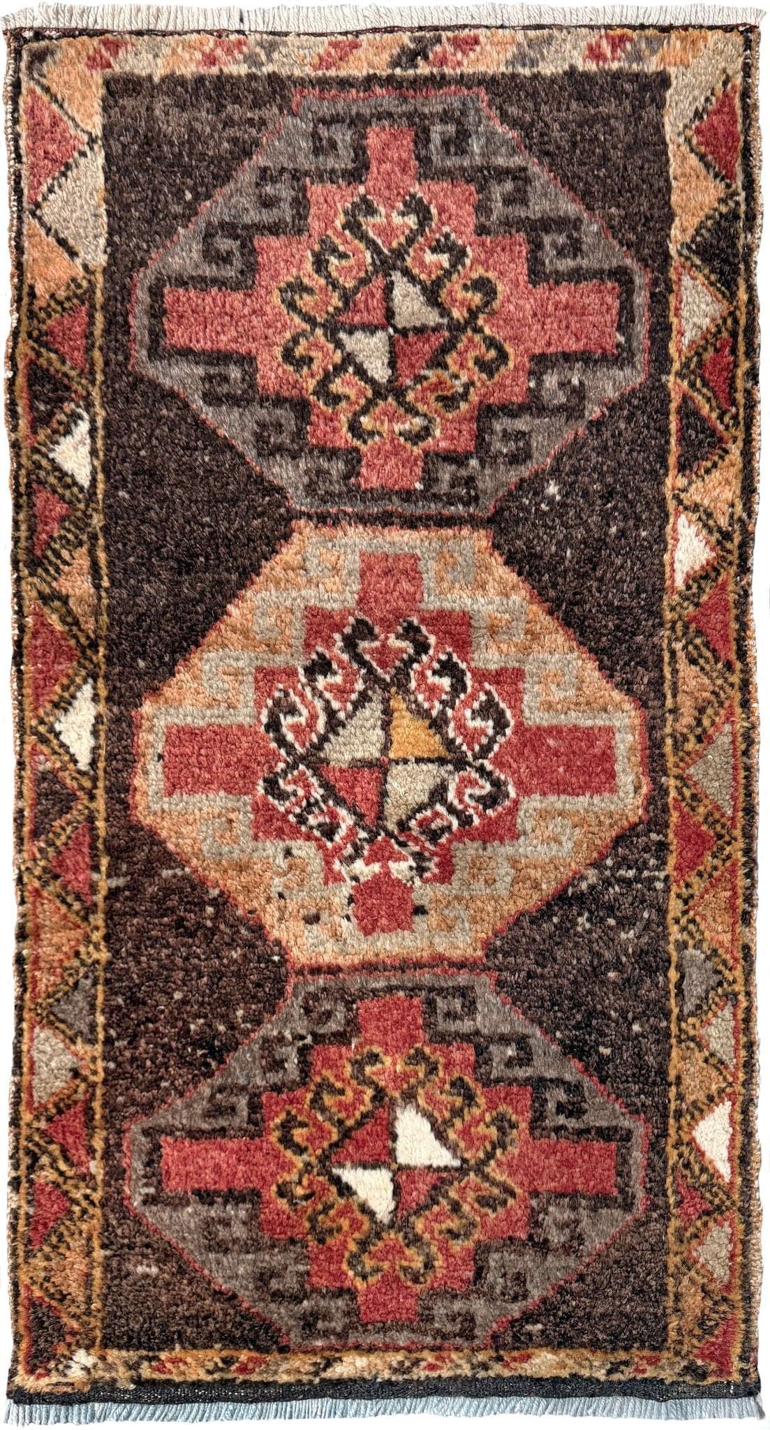 Vintage Turkish mini rug 21x39 with terracotta and brown geometric medallion design, handmade wool rug with earthy tones, perfect for entryway or bedside, from Indigo Rugs in the San Francisco Bay Area.