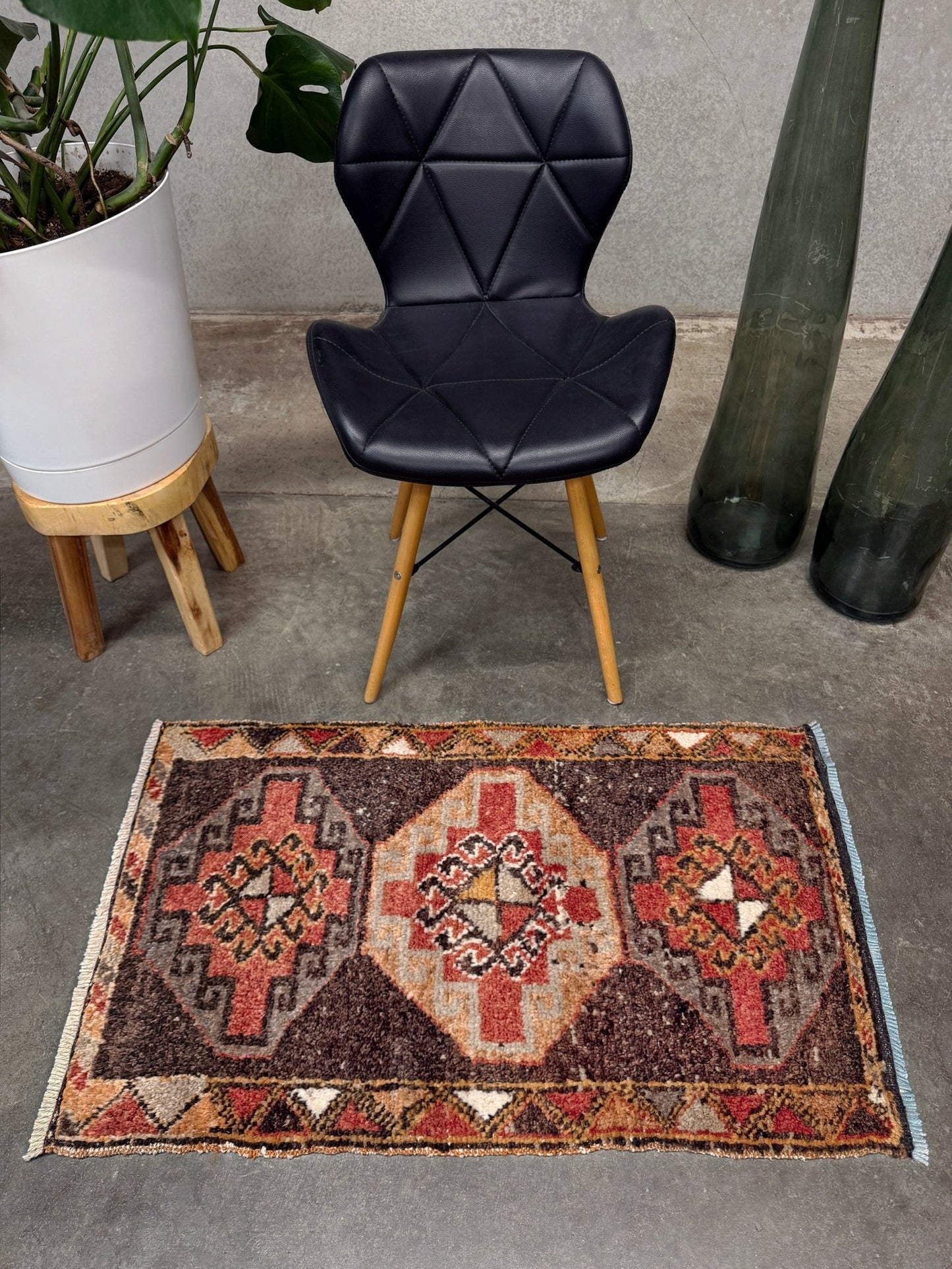 Vintage Turkish mini rug 21x39 with terracotta and brown geometric medallion design, handmade wool rug with earthy tones, perfect for entryway or bedside, from Indigo Rugs in the San Francisco Bay Area.