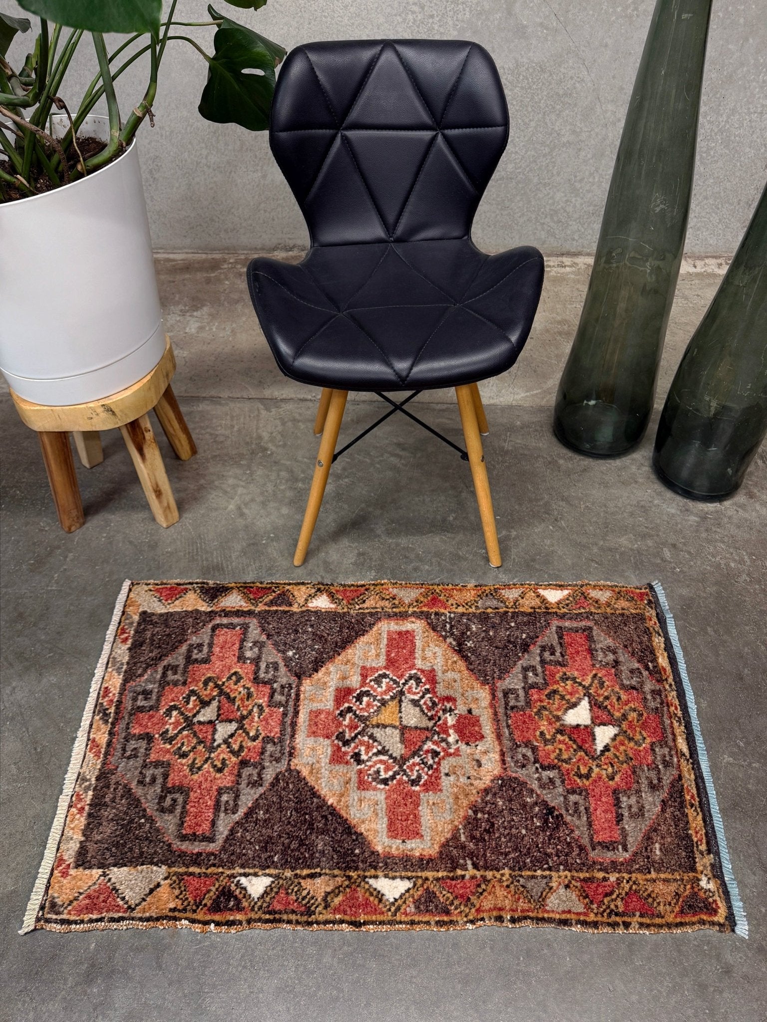 Vintage Turkish mini rug 21x39 with terracotta and brown geometric medallion design, handmade wool rug with earthy tones, perfect for entryway or bedside, from Indigo Rugs in the San Francisco Bay Area.
