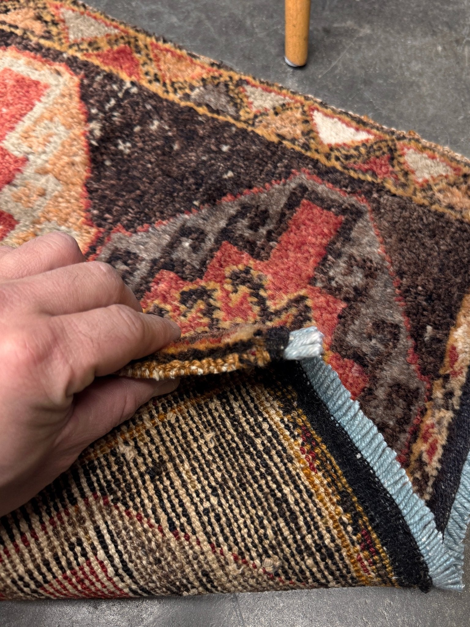 Vintage Turkish mini rug 21x39 with terracotta and brown geometric medallion design, handmade wool rug with earthy tones, perfect for entryway or bedside, from Indigo Rugs in the San Francisco Bay Area.