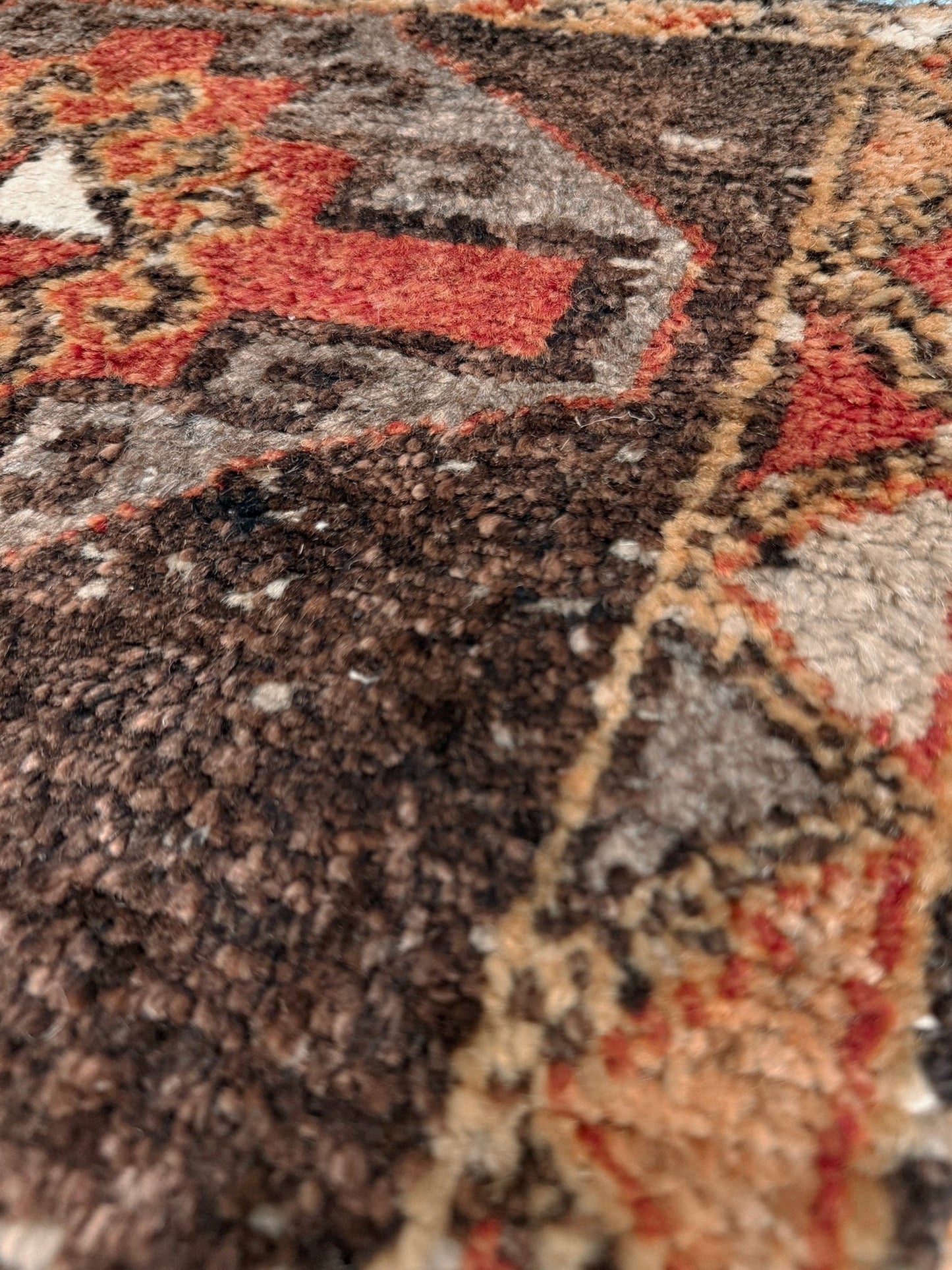 Vintage Turkish mini rug 21x39 with terracotta and brown geometric medallion design, handmade wool rug with earthy tones, perfect for entryway or bedside, from Indigo Rugs in the San Francisco Bay Area.