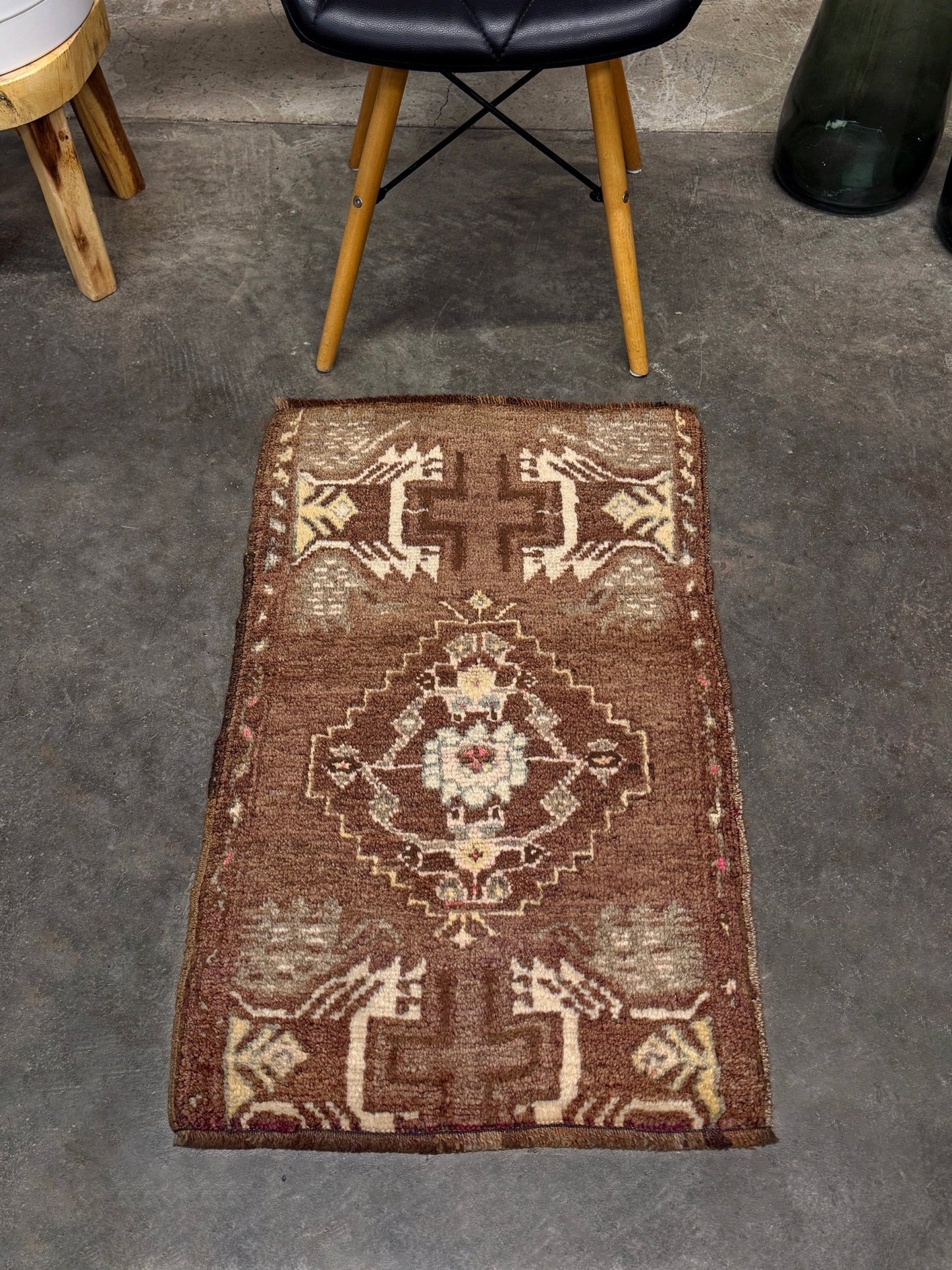 Vintage Turkish mini rug with earthy brown field and soft ivory geometric medallion, hand-knotted wool Anatolian village rug, 19x30 small accent rug for bedside, entryway, or wall art. From Indigo Rugs, Burlingame — San Francisco Bay Area.