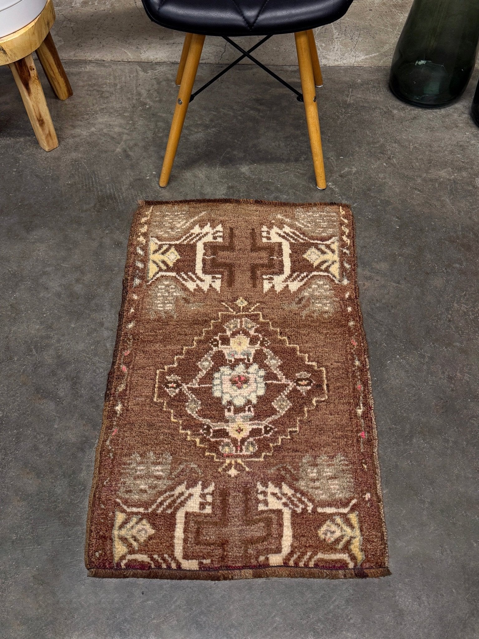Vintage Turkish mini rug with earthy brown field and soft ivory geometric medallion, hand-knotted wool Anatolian village rug, 19x30 small accent rug for bedside, entryway, or wall art. From Indigo Rugs, Burlingame — San Francisco Bay Area.