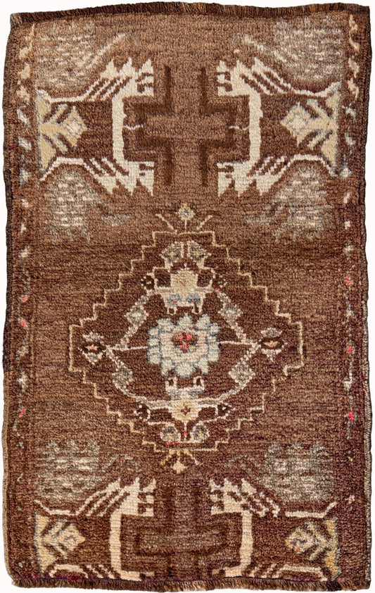 Vintage Turkish mini rug with earthy brown field and soft ivory geometric medallion, hand-knotted wool Anatolian village rug, 19x30 small accent rug for bedside, entryway, or wall art. From Indigo Rugs, Burlingame — San Francisco Bay Area.