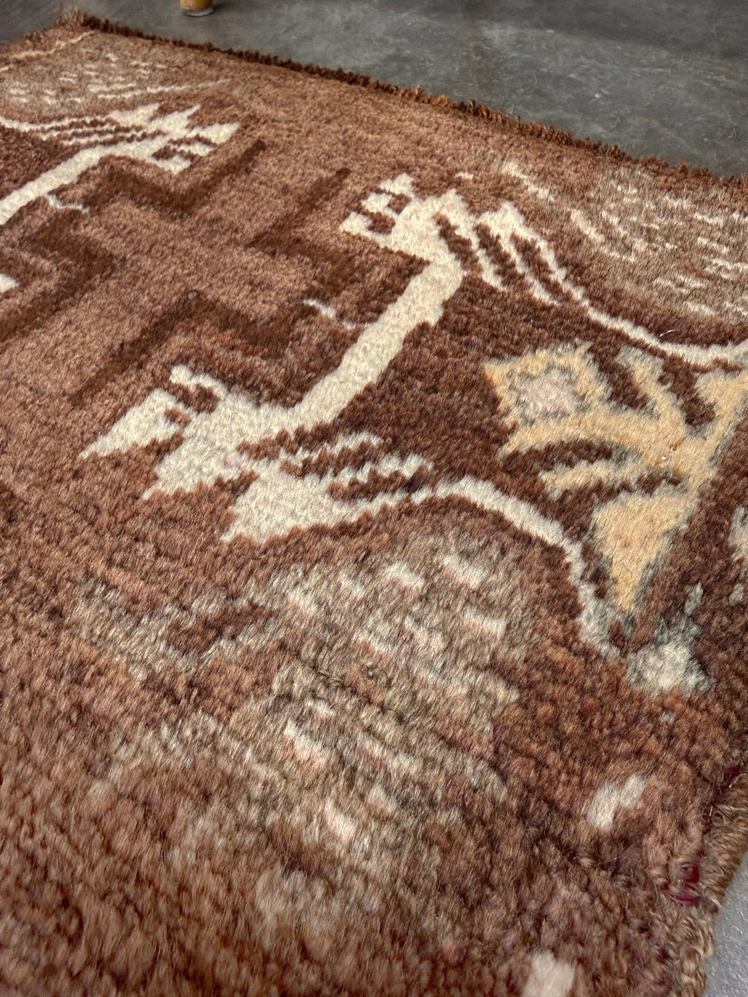 Vintage Turkish mini rug with earthy brown field and soft ivory geometric medallion, hand-knotted wool Anatolian village rug, 19x30 small accent rug for bedside, entryway, or wall art. From Indigo Rugs, Burlingame — San Francisco Bay Area.