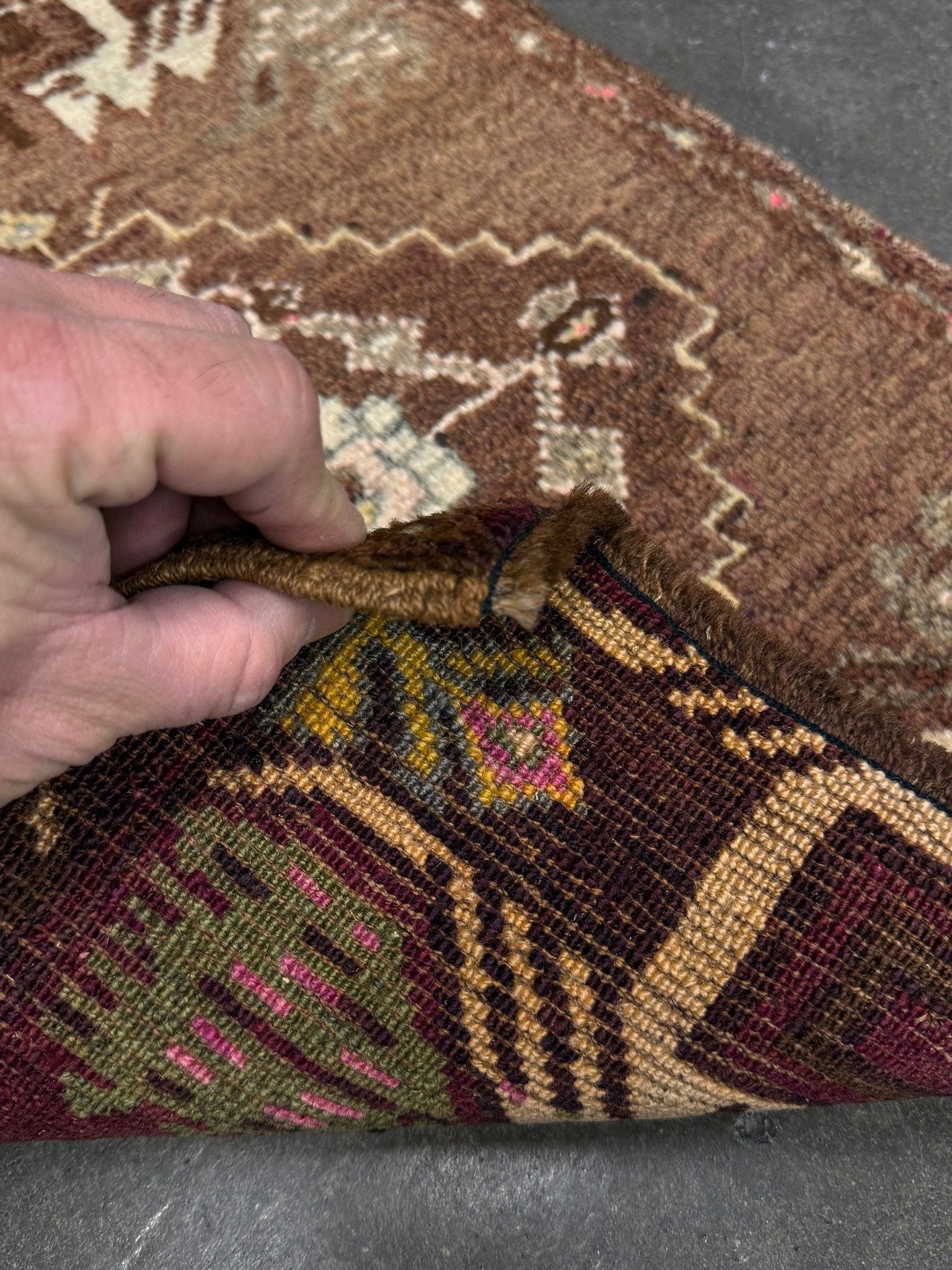 Vintage Turkish mini rug with earthy brown field and soft ivory geometric medallion, hand-knotted wool Anatolian village rug, 19x30 small accent rug for bedside, entryway, or wall art. From Indigo Rugs, Burlingame — San Francisco Bay Area.