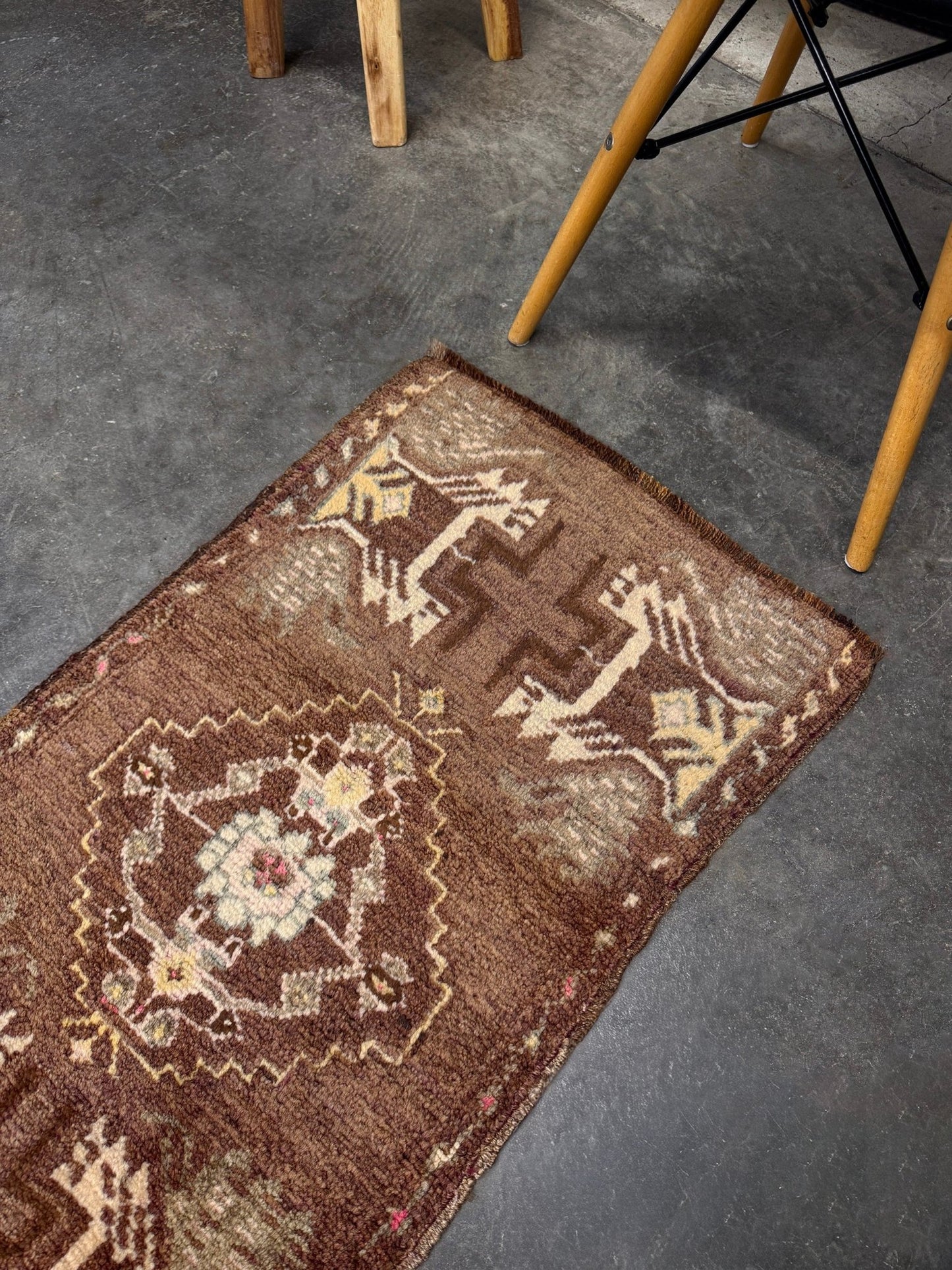 Vintage Turkish mini rug with earthy brown field and soft ivory geometric medallion, hand-knotted wool Anatolian village rug, 19x30 small accent rug for bedside, entryway, or wall art. From Indigo Rugs, Burlingame — San Francisco Bay Area.