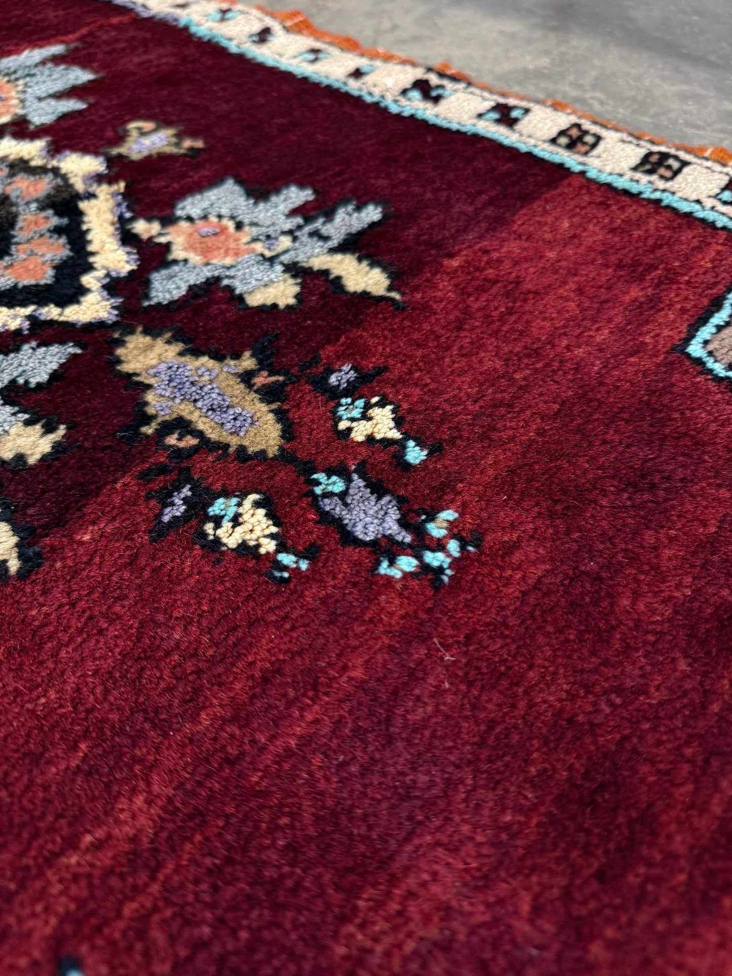 Vintage Turkish Yastik mini rug in ruby red. Hand-knotted wool, 20x33. One-of-a-kind rug from Indigo Rugs, the best rug shop in the San Francisco Bay Area (Burlingame, CA). Free shipping included.