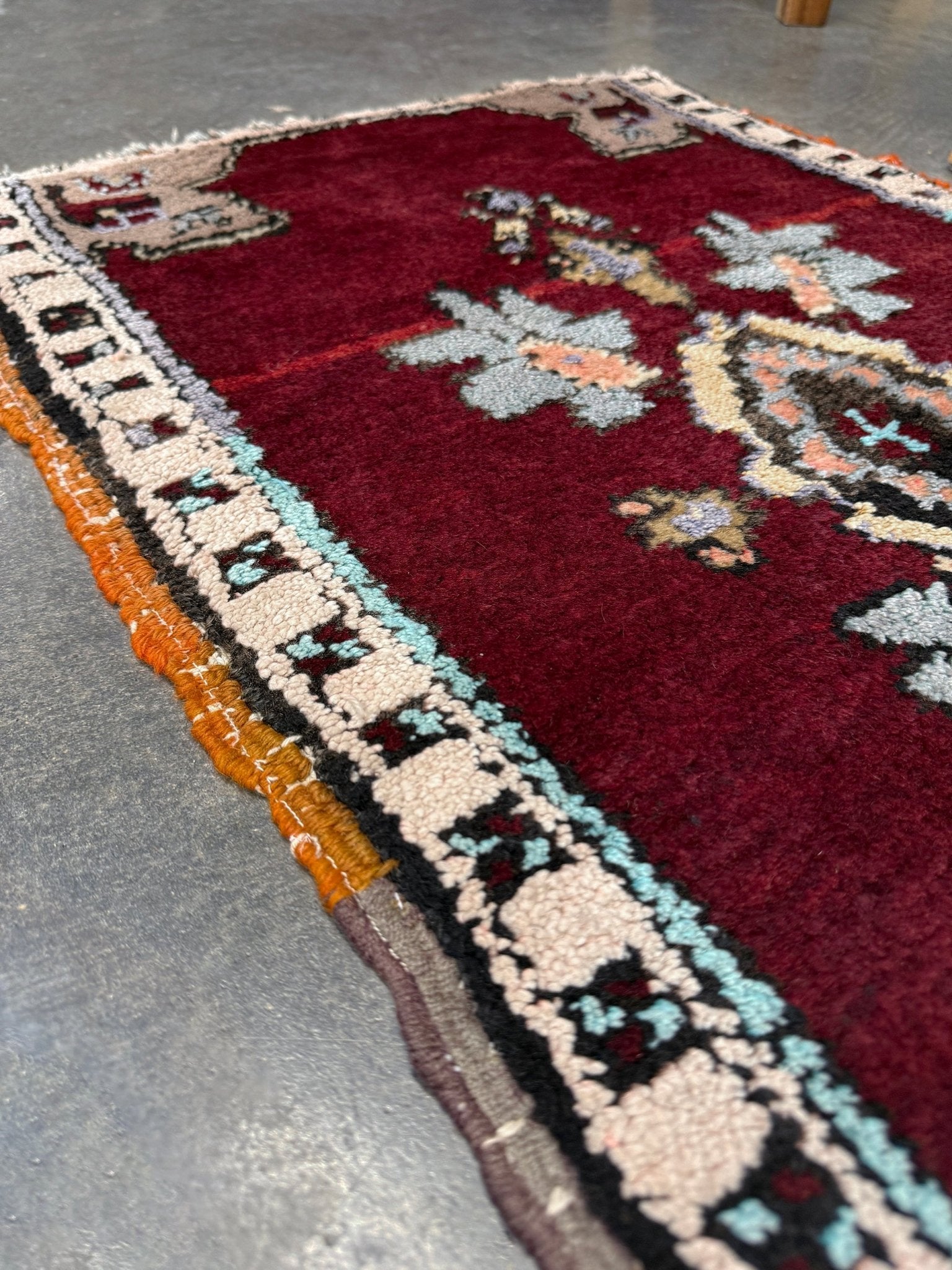 Vintage Turkish Yastik mini rug in ruby red. Hand-knotted wool, 20x33. One-of-a-kind rug from Indigo Rugs, the best rug shop in the San Francisco Bay Area (Burlingame, CA). Free shipping included.
