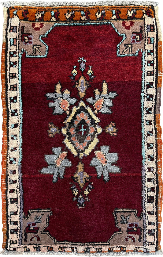 Vintage Turkish Yastik mini rug in ruby red. Hand-knotted wool, 20x33. One-of-a-kind rug from Indigo Rugs, the best rug shop in the San Francisco Bay Area (Burlingame, CA). Free shipping included.