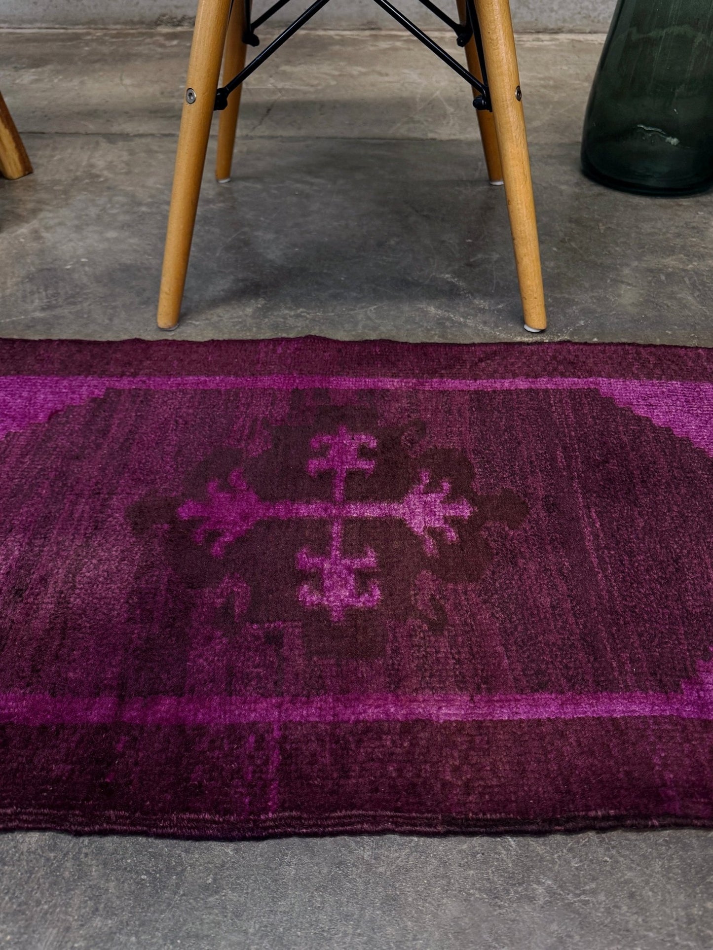 Magenta Purple Turkish mini rug with deep plum purple field, aubergine and blackberry shading, soft magenta border glow, and subtle geometric medallion. Handmade wool rug measuring 18 × 38 inches, perfect for entryways, kitchens, bedside spaces, or layered interiors.