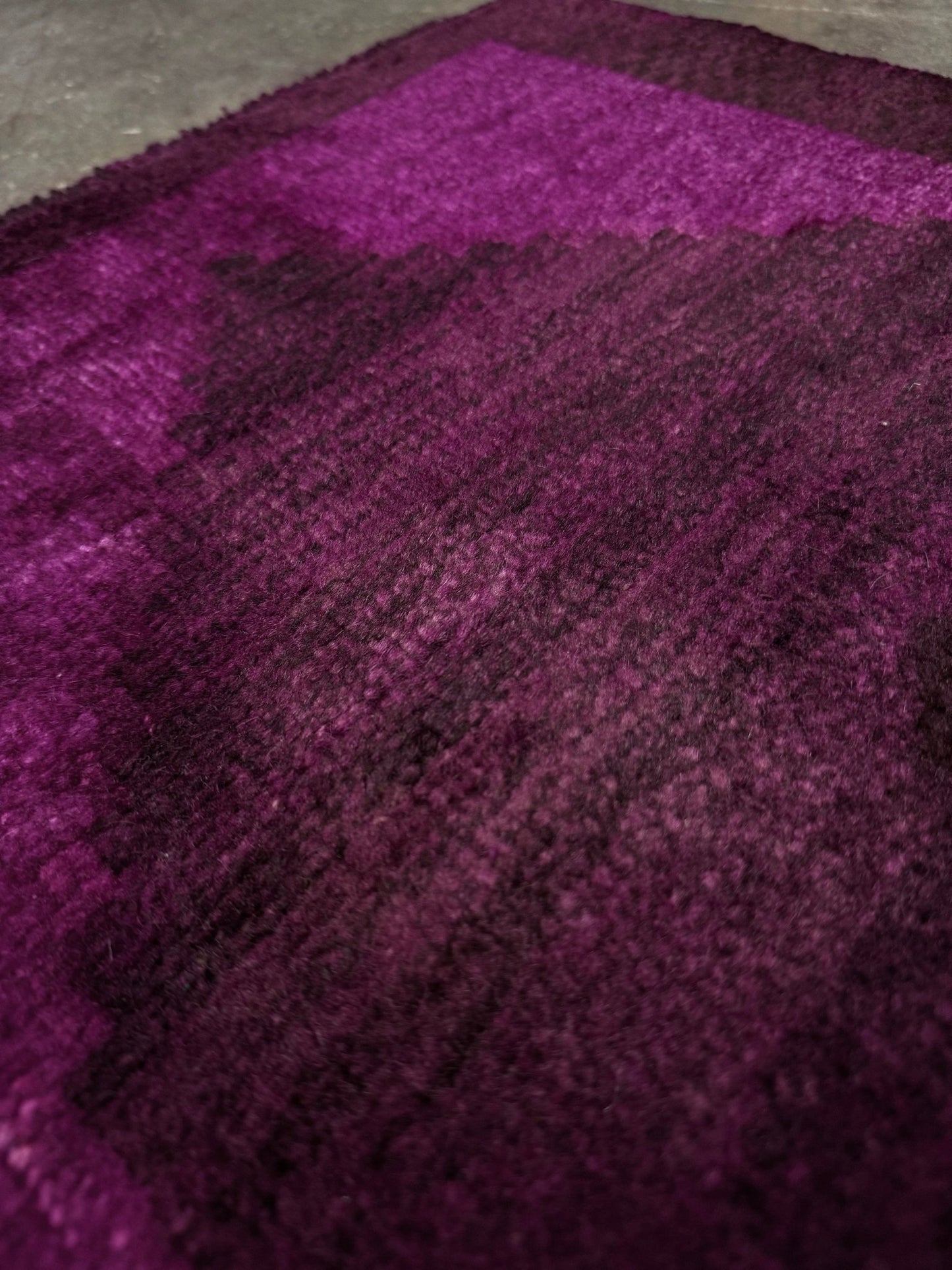 Magenta Purple Turkish mini rug with deep plum purple field, aubergine and blackberry shading, soft magenta border glow, and subtle geometric medallion. Handmade wool rug measuring 18 × 38 inches, perfect for entryways, kitchens, bedside spaces, or layered interiors.