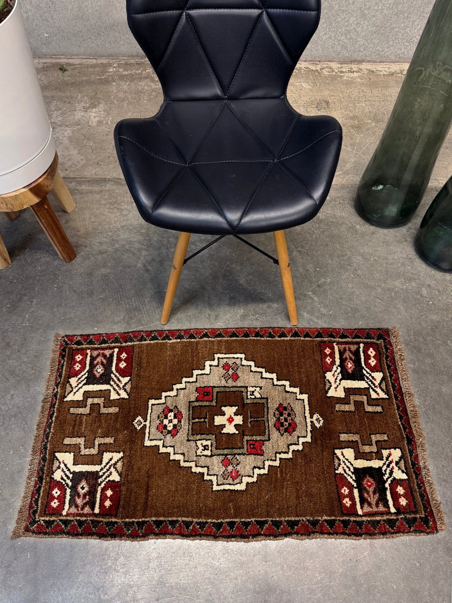 Vintage Turkish Yastik mini rug in walnut brown with taupe and camel medallion, espresso outlines, ivory highlights, and crimson red accents. Hand-knotted wool, 21x37 inches. One-of-a-kind rug from Indigo Rugs, the best rug shop in the San Francisco Bay Area (Burlingame, CA). Free shipping included.