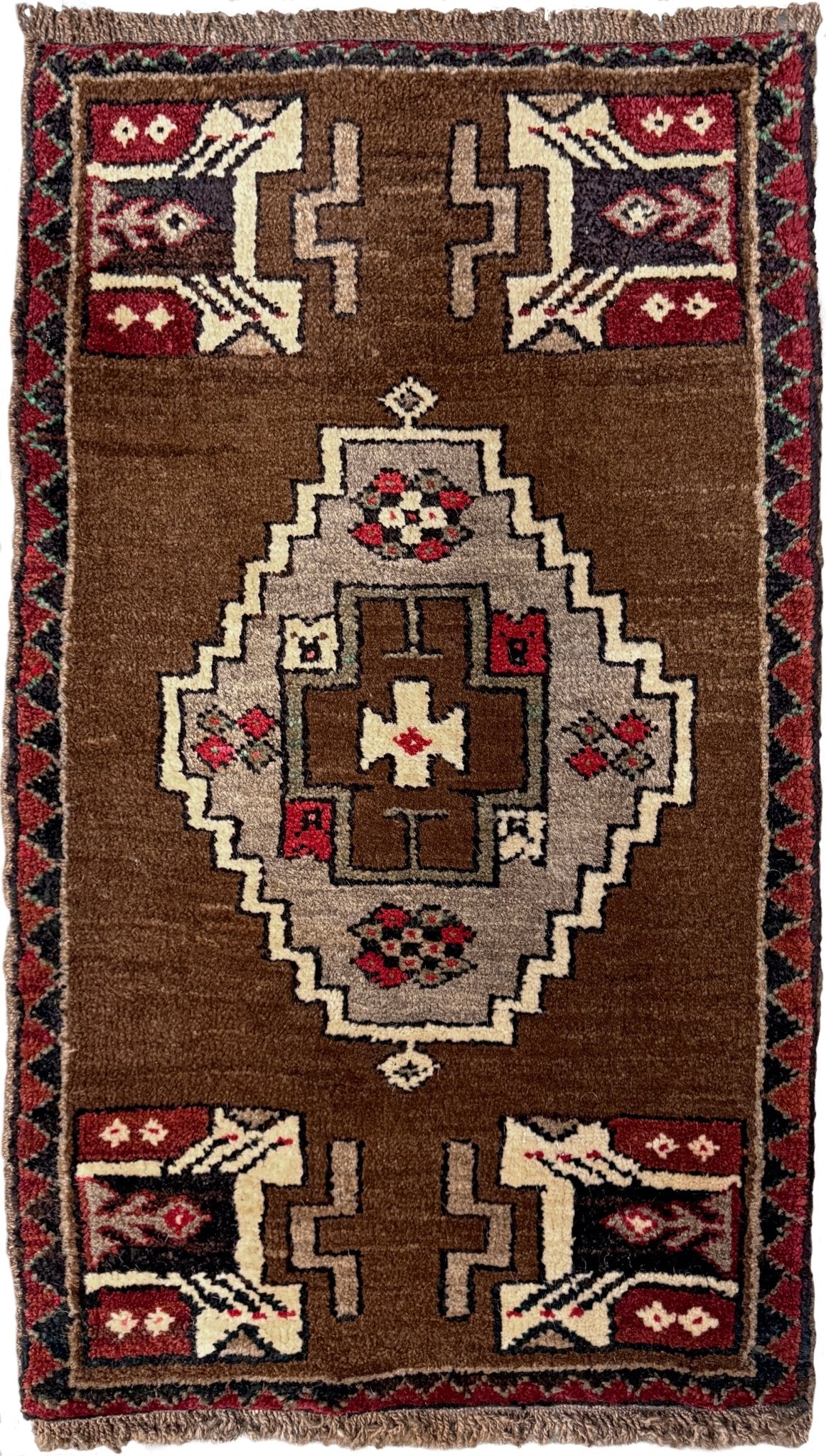 Vintage Turkish Yastik mini rug in walnut brown with taupe and camel medallion, espresso outlines, ivory highlights, and crimson red accents. Hand-knotted wool, 21x37 inches. One-of-a-kind rug from Indigo Rugs, the best rug shop in the San Francisco Bay Area (Burlingame, CA). Free shipping included.