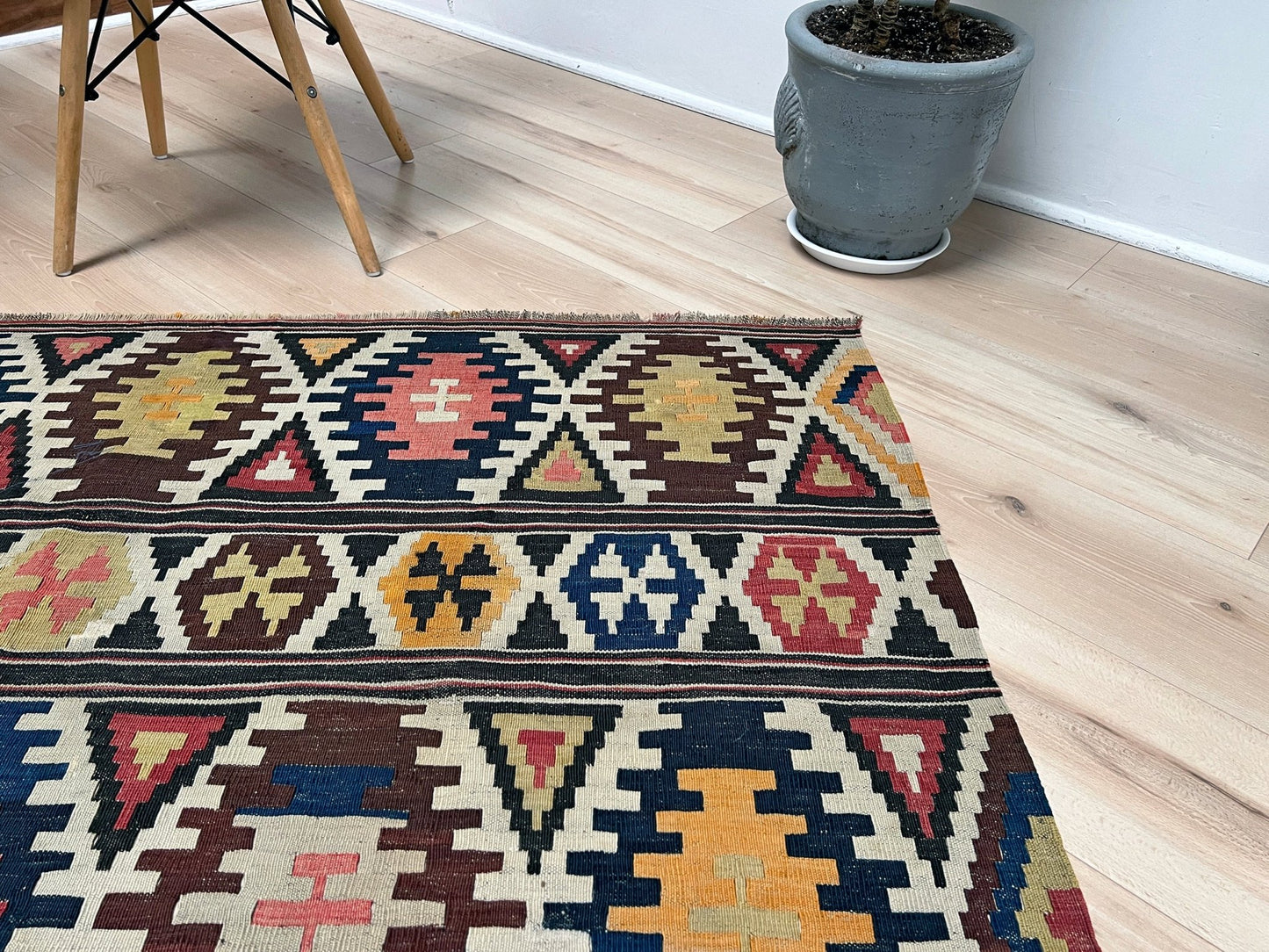 Kazak caucasian tribal kilim rug with vibrant rug. Handmade in living room setting. Flatweave rug shop Bay Area SF, California.  Wool rug for nursery Bright colors, bold color, rug store, rug shop  Palo Alto, berkeley, vintage rug, modern kilim, warm colors, antique rug.