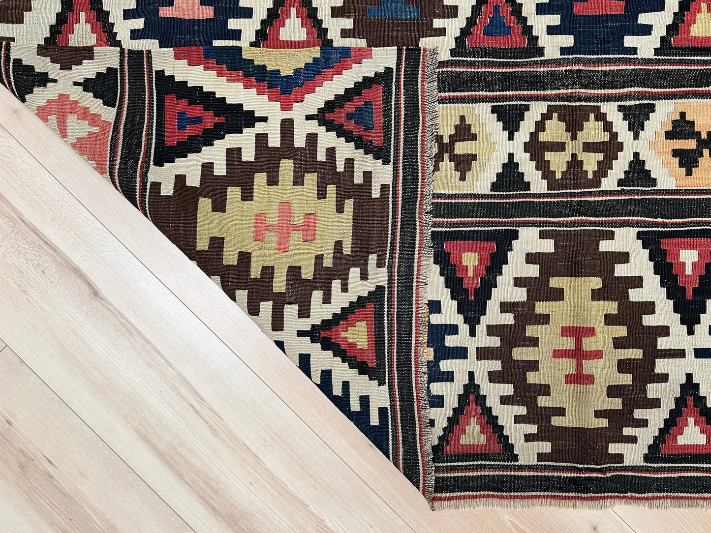 Kazak caucasian tribal kilim rug with vibrant rug. Handmade in living room setting. Flatweave rug shop Bay Area SF, California.  Wool rug for nursery Bright colors, bold color, rug store, rug shop  Palo Alto, berkeley, vintage rug, modern kilim, warm colors, antique rug.