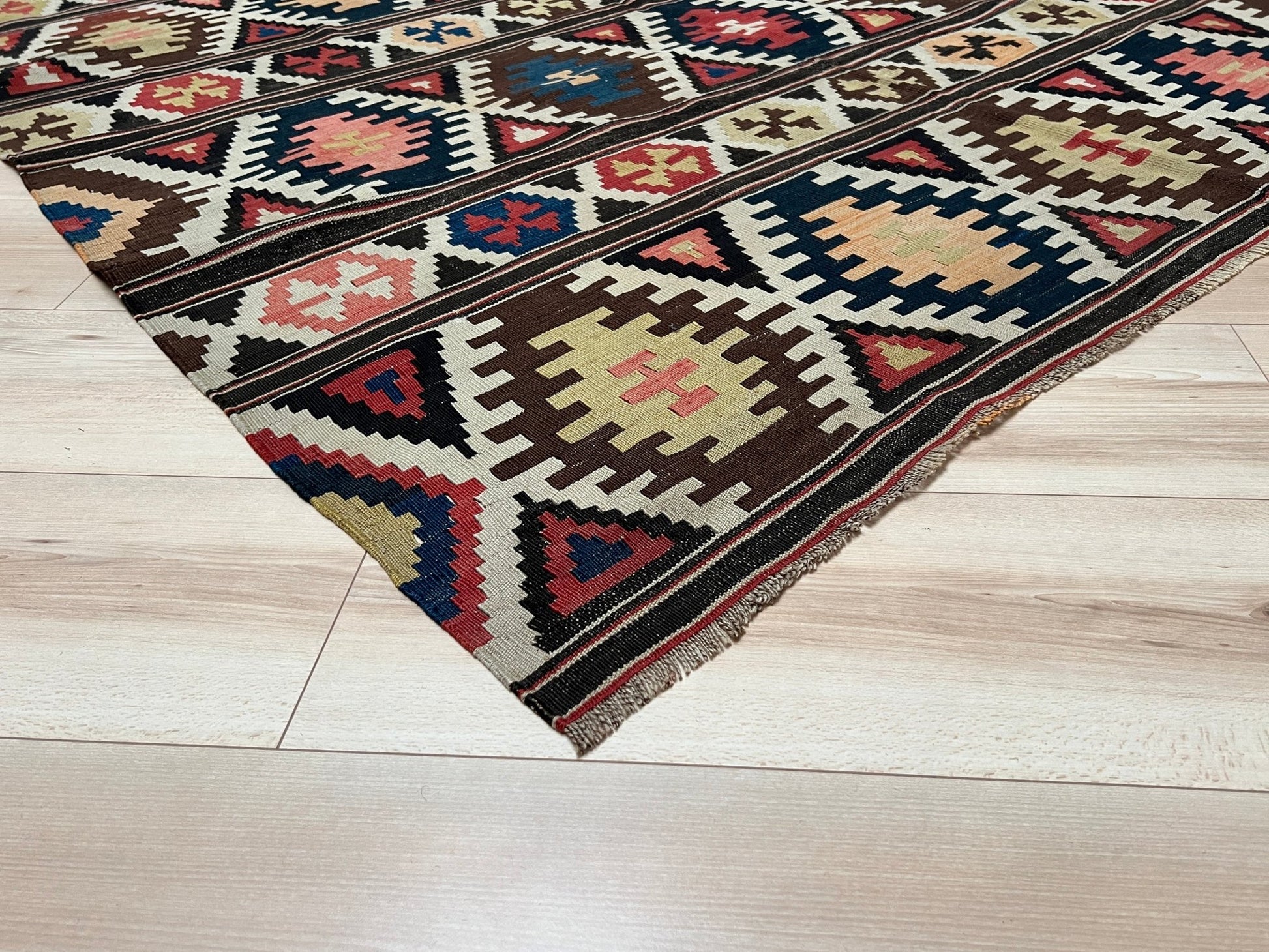 Kazak caucasian tribal kilim rug with vibrant rug. Handmade in living room setting. Flatweave rug shop Bay Area SF, California.  Wool rug for nursery Bright colors, bold color, rug store, rug shop  Palo Alto, berkeley, vintage rug, modern kilim, warm colors, antique rug.