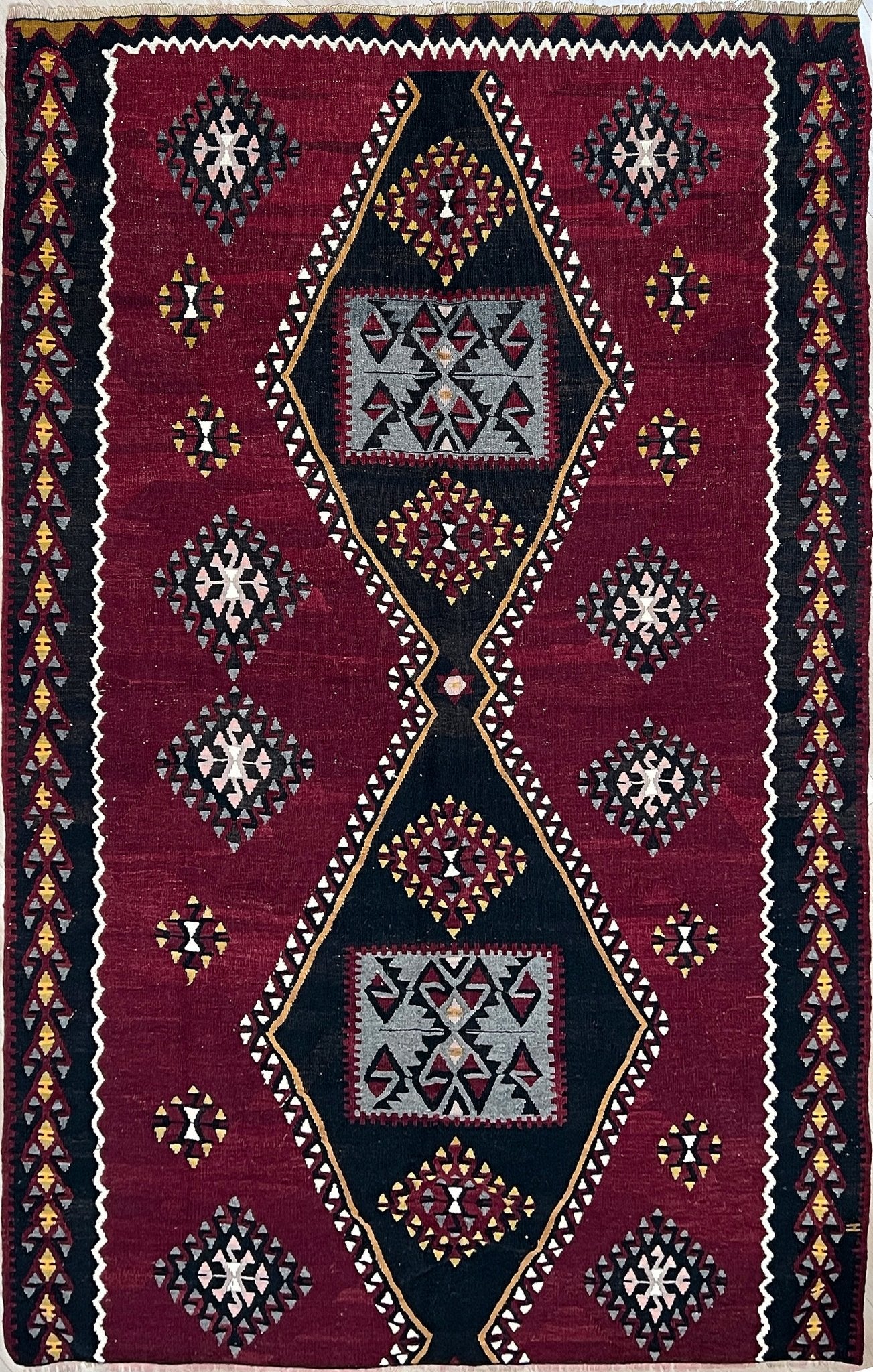 kayseri vintage turkish rug shop Sf Bay Area. Buy handmade wool flatweave rug. Vibrant color warm color rug in living room setting. 